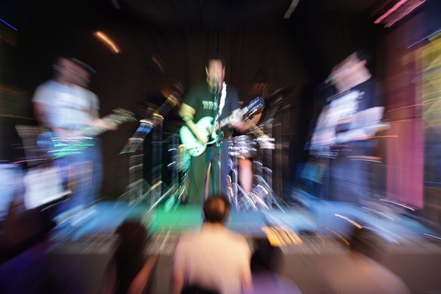 The New Relics band performing on stage in front of crowd